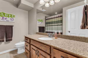 Bathroom with vanity, a shower with shower curtain, and light tile patterned floors