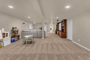 Game room with light colored carpet and recessed lighting