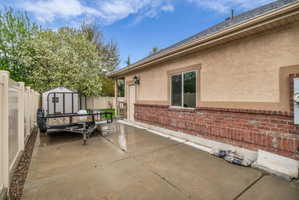 Fenced backyard with a patio and a storage shed