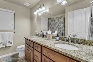 Bathroom with double vanity and curtained shower