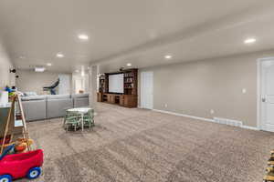 Recreation room with recessed lighting and carpet