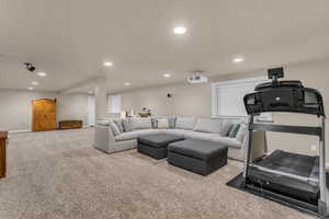 Carpeted living room with recessed lighting