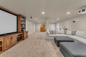 Living room with recessed lighting, light carpet, and a heating unit