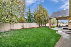 Fenced backyard with a patio