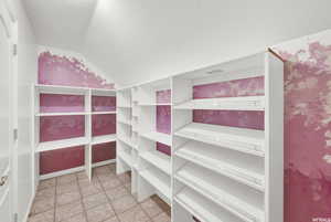 Walk in closet with lofted ceiling