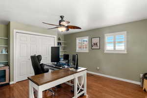 Office featuring a ceiling fan and dark wood-type flooring
