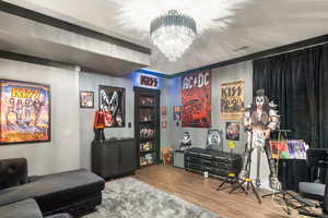 Playroom with wood finished floors and a chandelier
