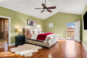 Bedroom with access to outside, hardwood / wood-style flooring, a ceiling fan, and arched walkways