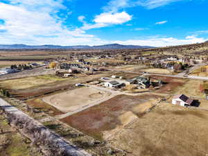 Overview of rural landscape with nearby suburban area and a mountain backdrop