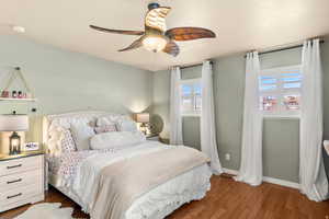 Bedroom featuring dark wood finished floors and a ceiling fan