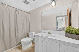 Full bath featuring curtained shower, vanity, ensuite bath, and light tile patterned floors