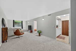 Living room featuring light carpet and baseboards