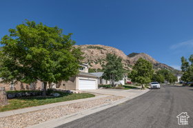View of asphalt street with a mountain view and sidewalks