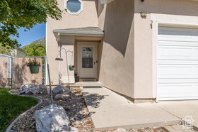 Entrance to property with stucco siding and a garage