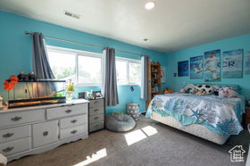 Bedroom featuring light carpet and recessed lighting