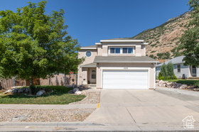 View of front of house featuring concrete driveway and an attached garage
