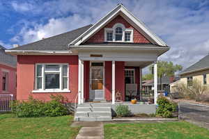 View of front of house with a porch and roof with shingles