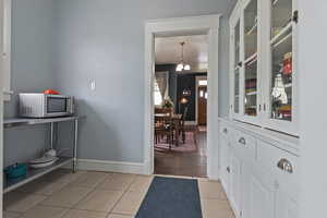 Foyer entrance featuring baseboards and light tile patterned floors