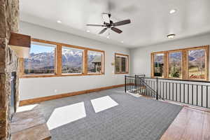 Unfurnished room with a mountain view, a ceiling fan, and recessed lighting