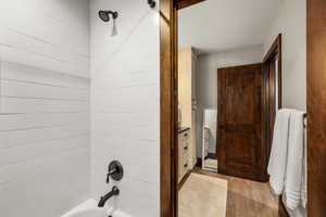 Bathroom featuring shower / tub combination and light wood-style floors