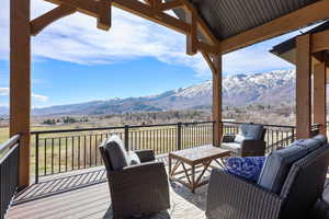 Deck with a mountain view, an outdoor lounge area, and a patio