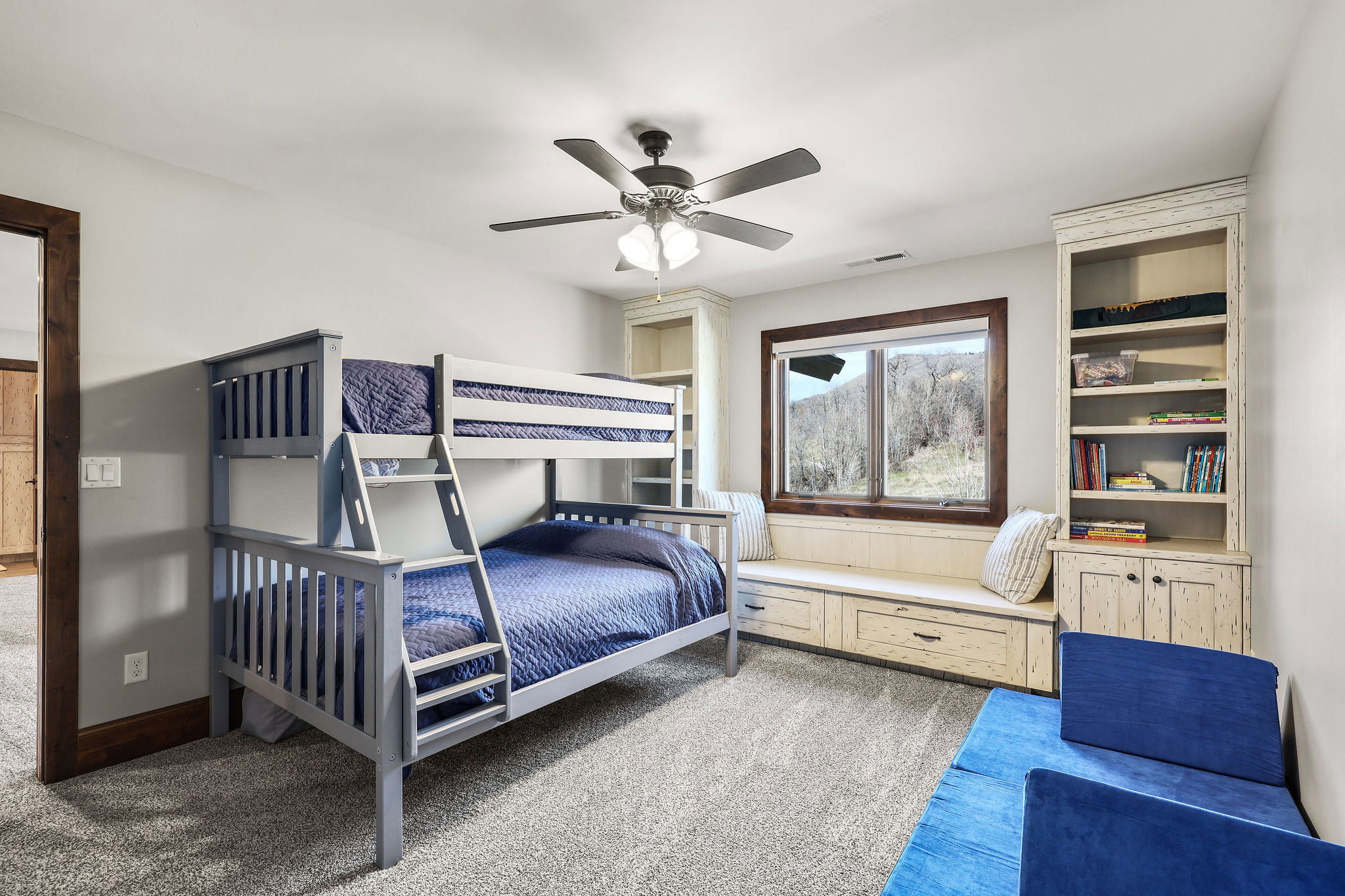Bedroom with light colored carpet and a ceiling fan