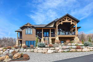 View of front facade with stone siding and stairway