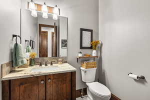 Half bath featuring toilet and vanity