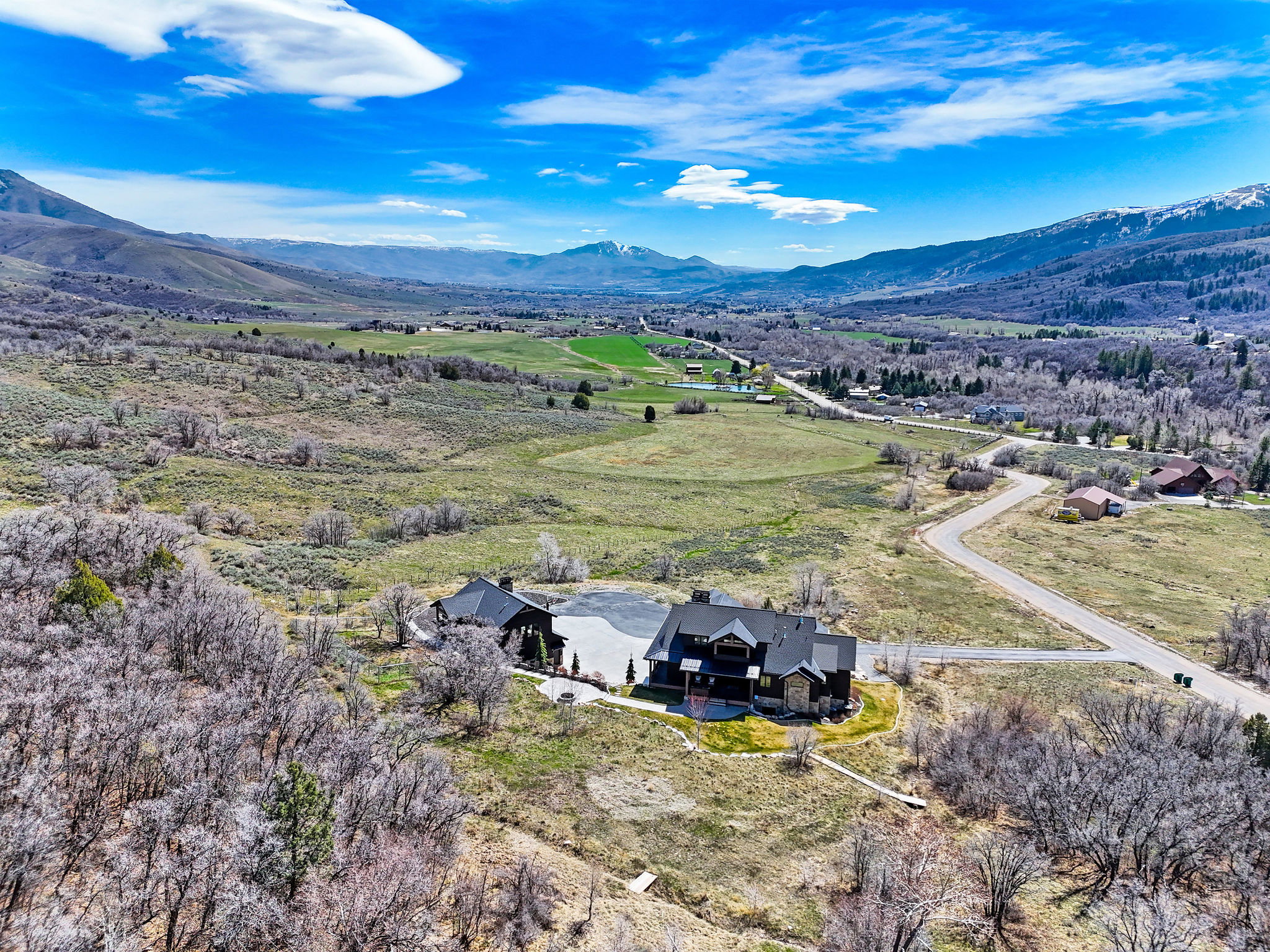 Aerial view of property and surrounding area with a mountainous background