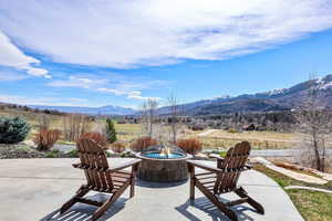 View of patio / terrace featuring a mountain view and an outdoor fire pit