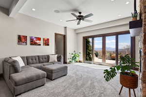 Carpeted living area featuring a mountain view, ceiling fan, and recessed lighting