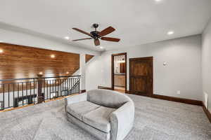 Living area featuring ceiling fan, carpet floors, recessed lighting, and lofted ceiling