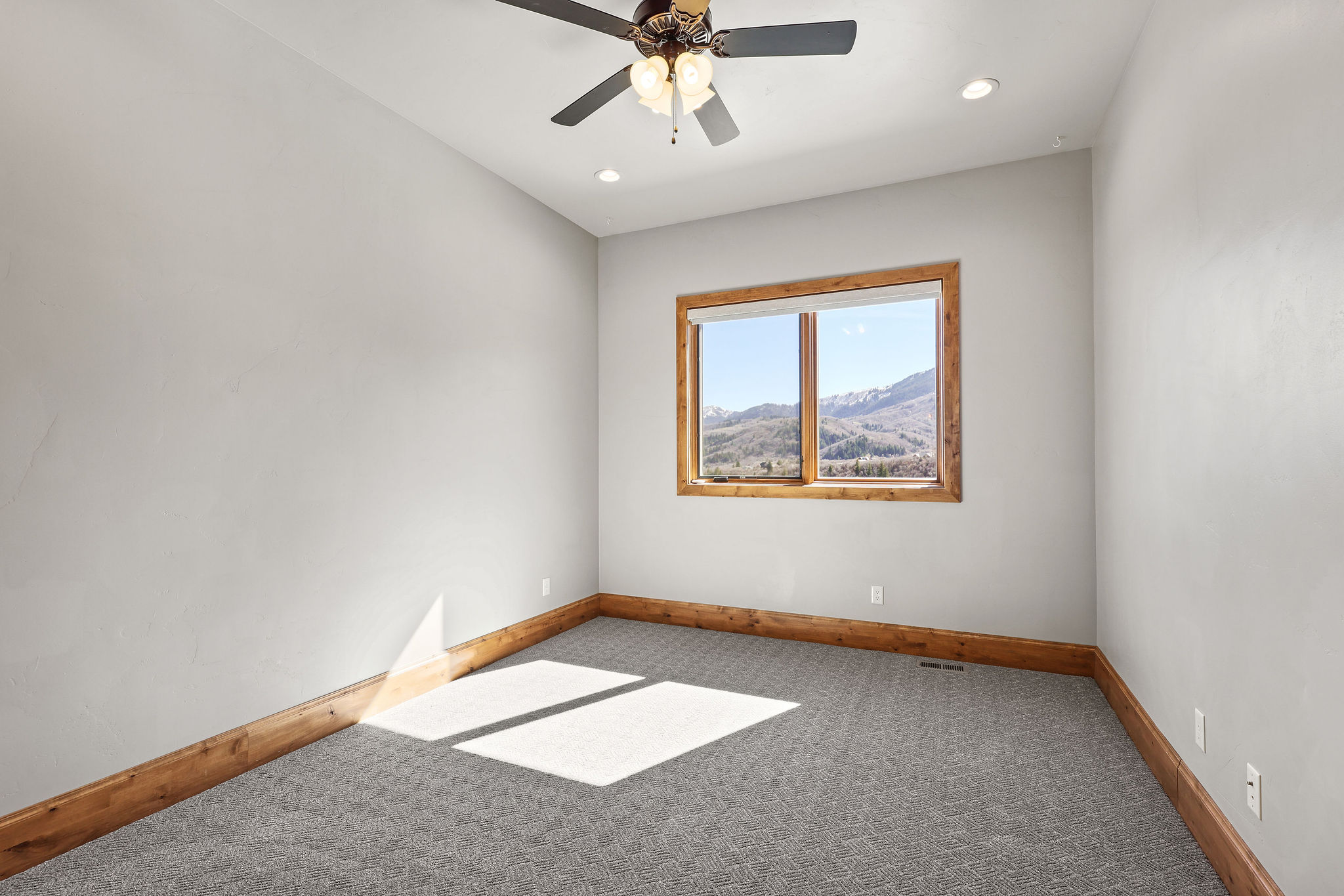 Spare room featuring light colored carpet, ceiling fan, recessed lighting, and a mountain view