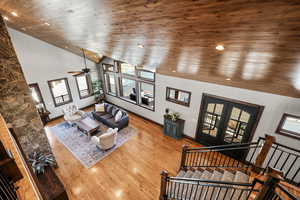 Living area with french doors, a vaulted wooden ceiling, ceiling fan, and wood-type flooring