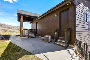 Property entrance with a patio and a mountain view