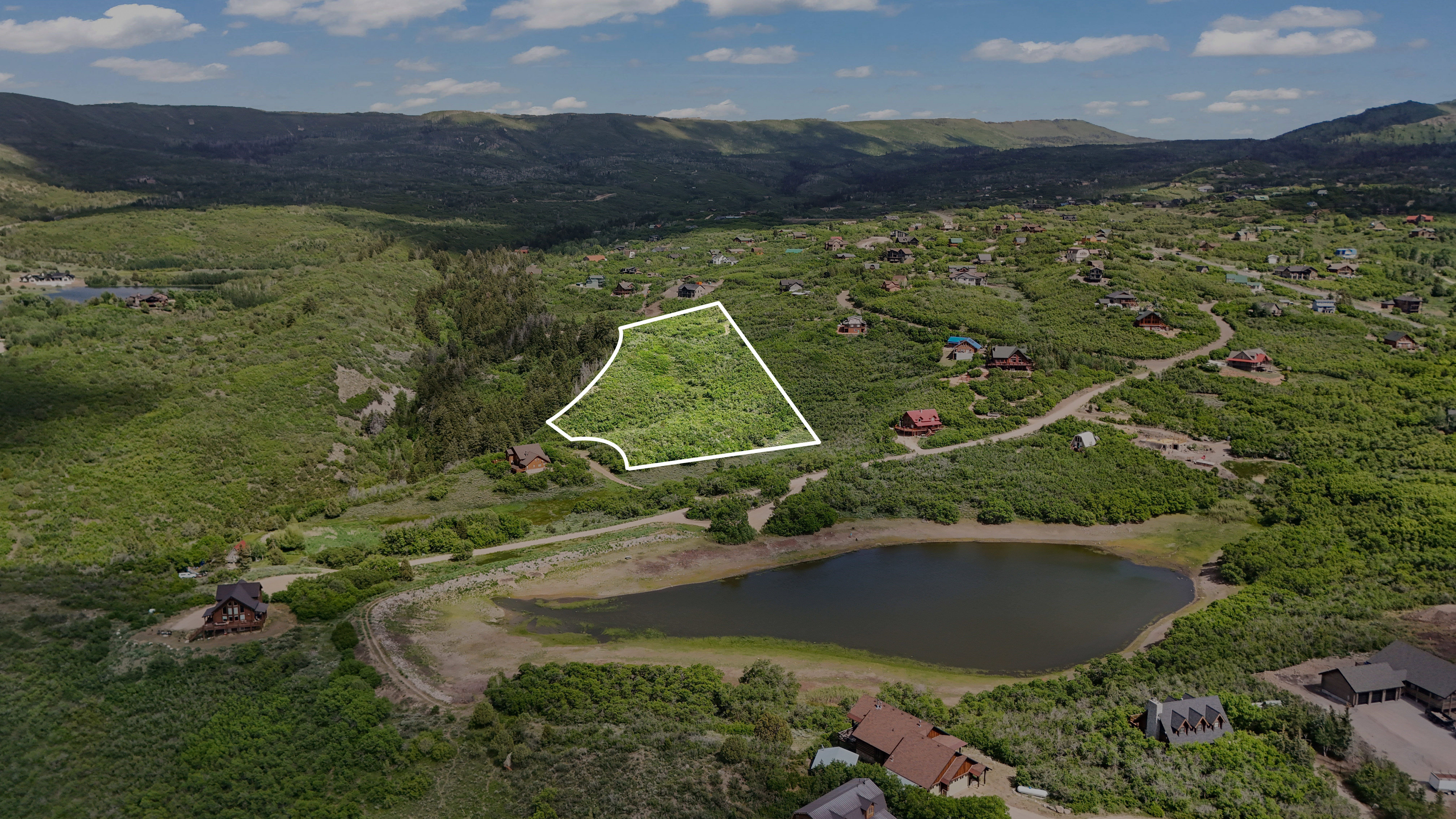 View of property location with property boundaries highlighted and a water and mountain view