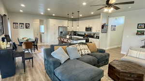 Living area featuring light wood finished floors, recessed lighting, ceiling fan, and washer / clothes dryer