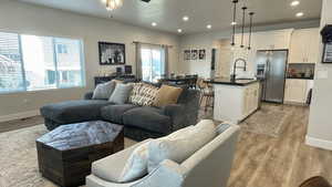 Living room featuring recessed lighting, light wood-style floors, and ceiling fan