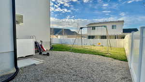 Fenced backyard with a playground
