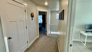 Hall with light colored carpet