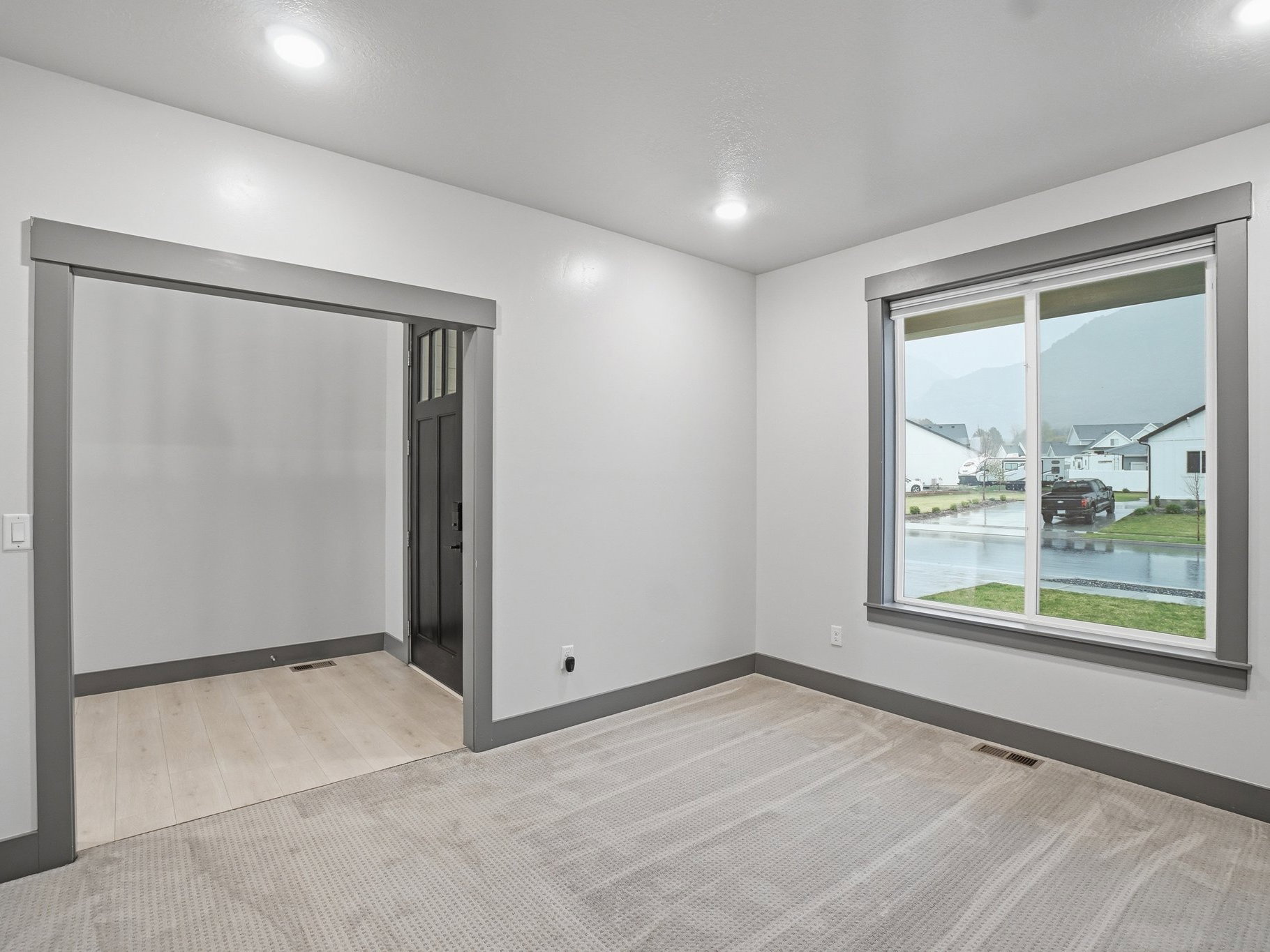 Empty room featuring light colored carpet and a water view