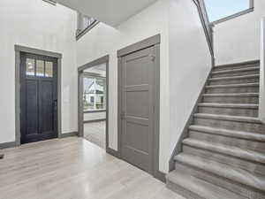 Entrance foyer with a high ceiling and light wood-type flooring