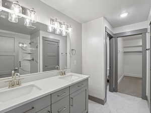 Bathroom featuring double vanity and a shower stall