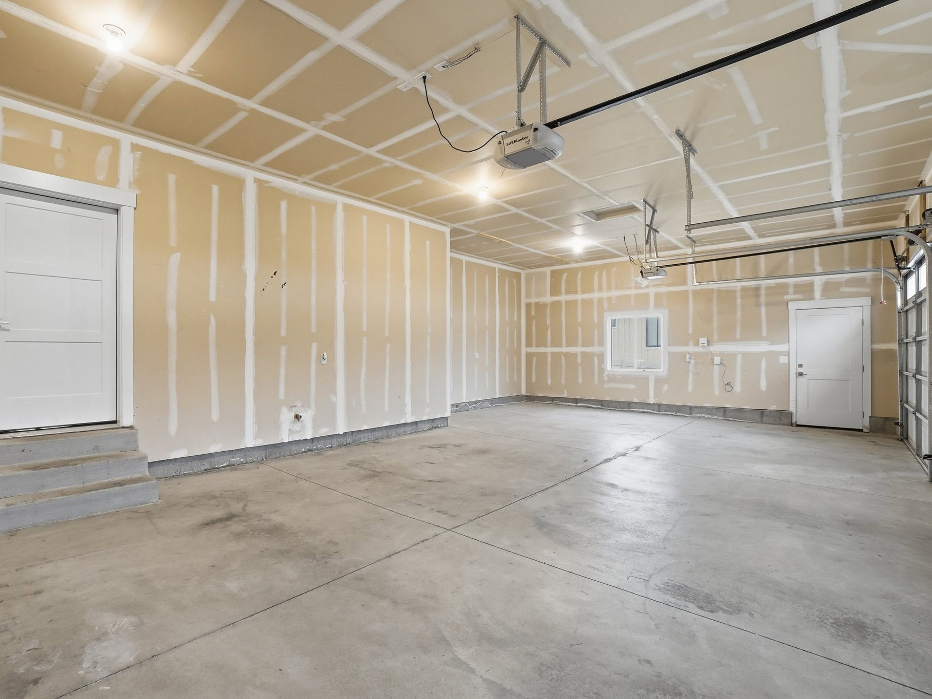 Garage featuring a garage door opener
