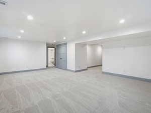 Finished basement featuring light colored carpet and recessed lighting