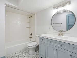 Full bath with vanity,  shower combination, and a textured ceiling