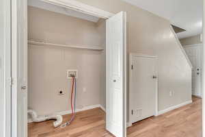 Laundry area featuring washer hookup, light wood-style flooring, and hookup for an electric dryer