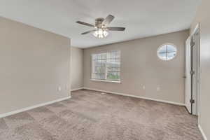 Unfurnished room featuring ceiling fan and carpet flooring