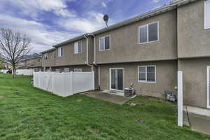 Back of house featuring a patio area and stucco siding