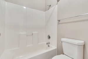 Full bathroom with toilet and shower / tub combination